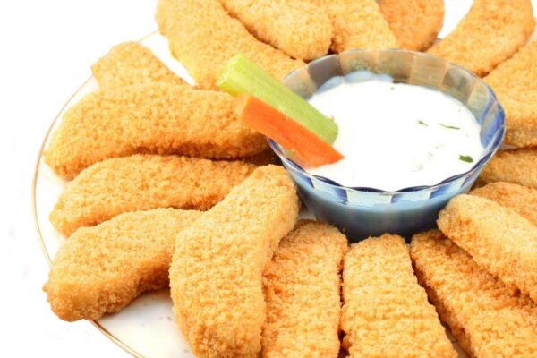 a platter of chicken fingers with ranch